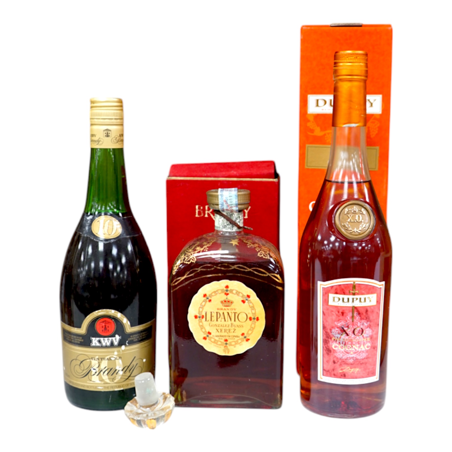 Three bottles of brandy comprising KWV Ten Year brandy, Dupuy cognac and Lepanto brandy. Condition - fair, storage history unknown